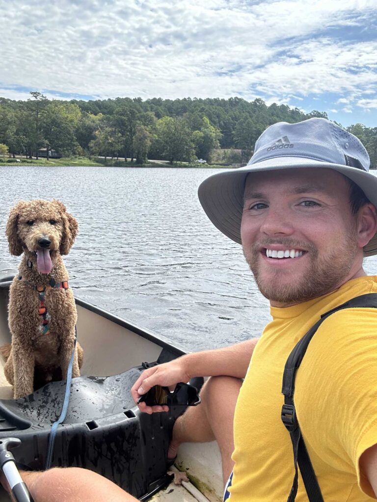 Connor enjoying a lake day with his dog.