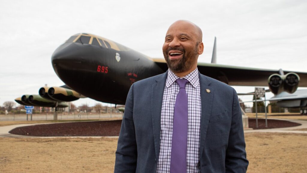 Eric Hinton smiling in front of a plane.