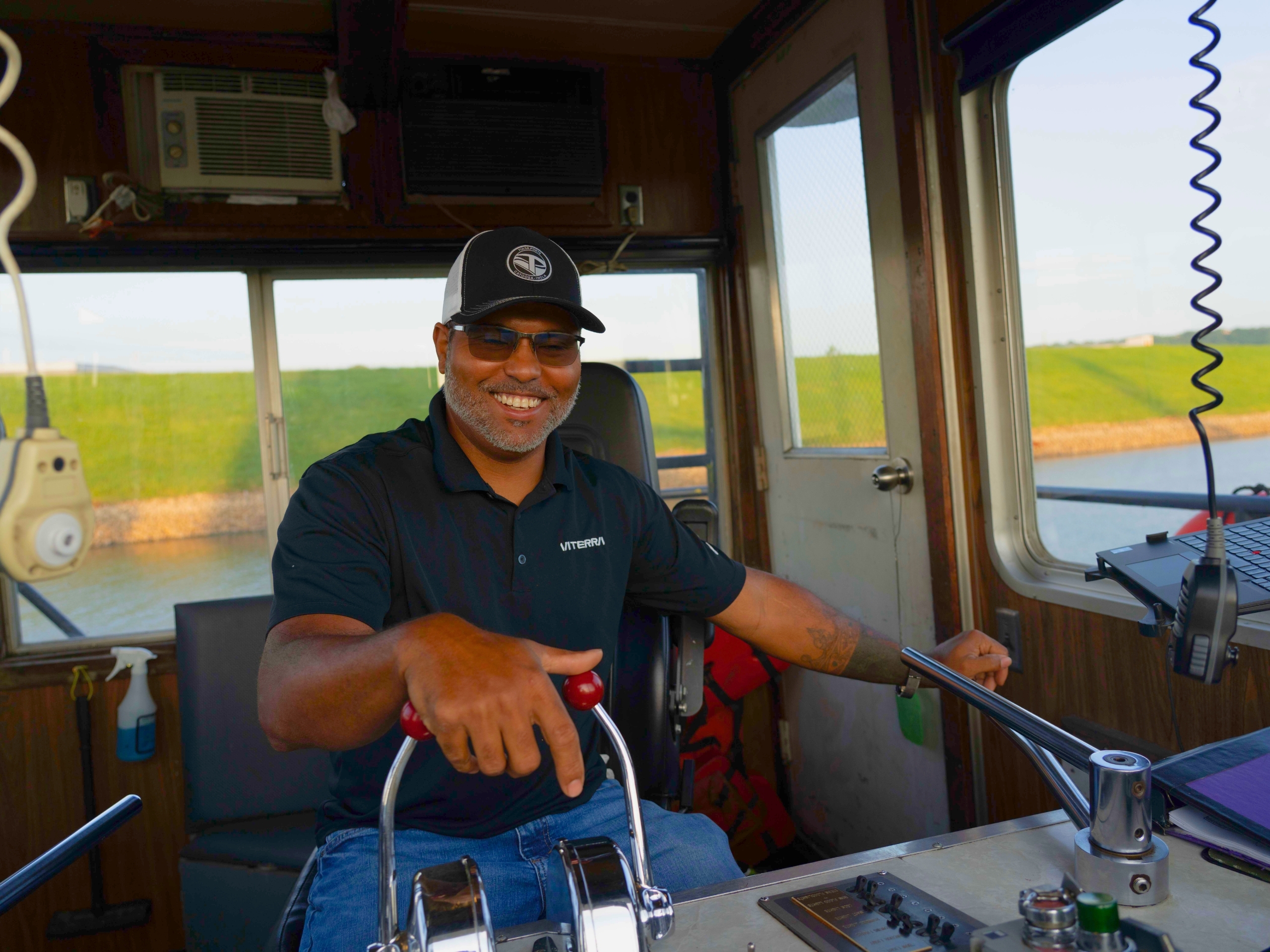 A happily employed man operating a boat on a river in Oklahoma. Oklahoma is one of the easiest states to find a job.